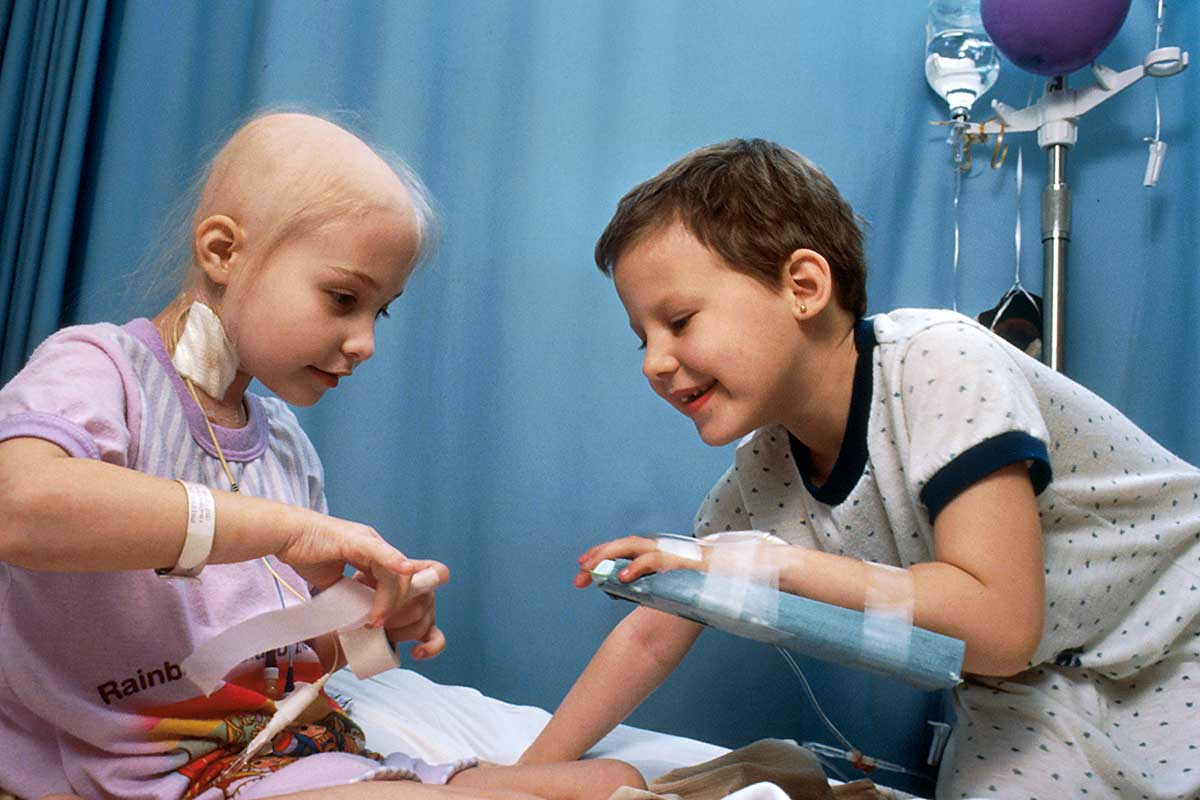 Image of two young girls with acute lymphocytic leukemia (ALL) receiving chemotherapy.